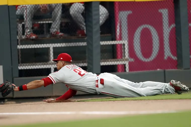 Phillies leftfielder Aaron Altherr tries to make a diving catch on Freddie Freeman's third-inning double in the Braves' 8-3 victory Thursday night in Atlanta.