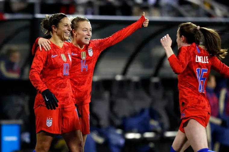 Carli Lloyd (left) celebrates with Emily Sonnett (center) and Rose Lavelle (right) after scoring the United States' second goal against Sweden.