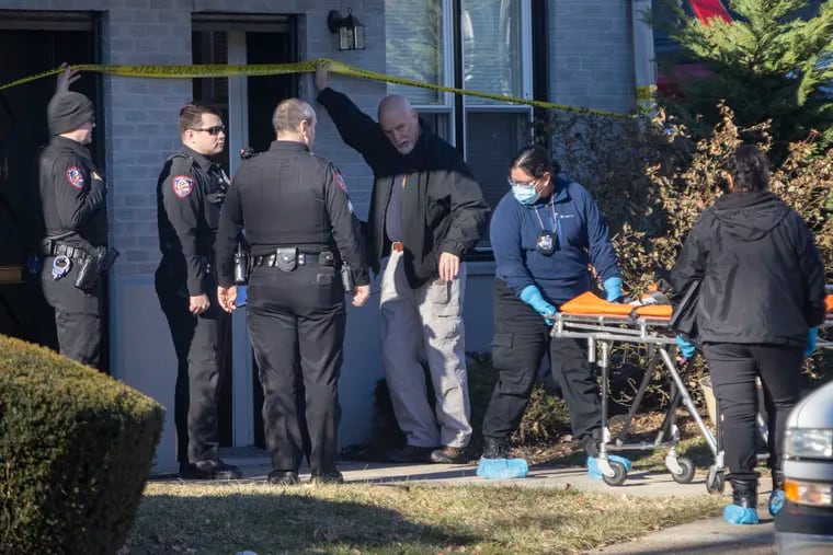 Staff from the Delaware County Medical Examiner's Office move a gurney into the Willows apartments along the 400 block of South Springfield Road in Clifton Heights on Friday.