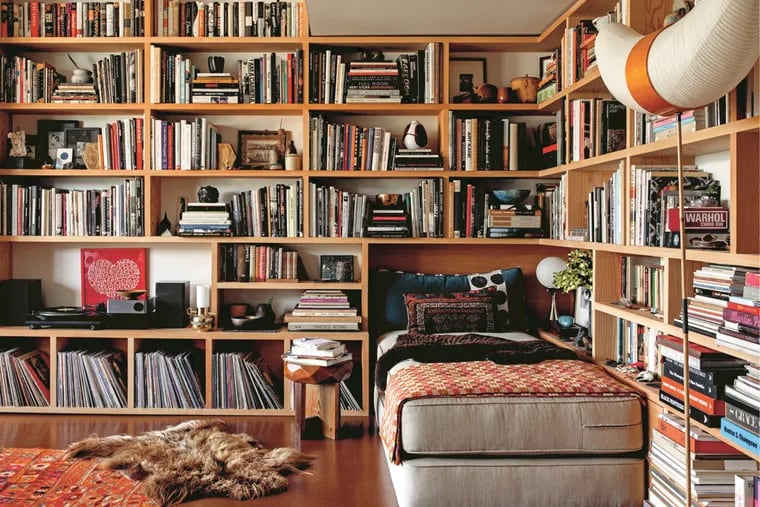A reading nook in the Los Angeles home of Roman Alonso is layered and colorful, with a daybed, records, pottery and books. Nina Freudenberger's book "Bibliostyle: How We Live at Home with Books" showcases bookshelves from around the world.