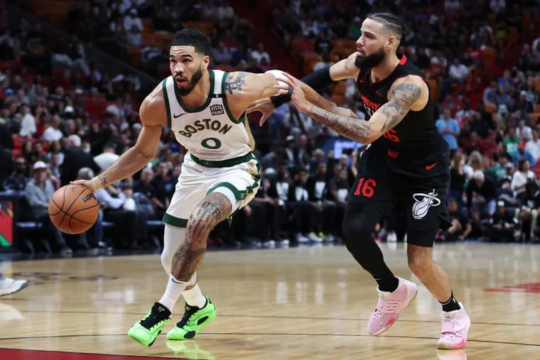 Jayson Tatum #0 of the Boston Celtics drives against Caleb Martin #16 of the Miami Heat during the first quarter of the game at Kaseya Center on February 11, 2024 in Miami, Florida.