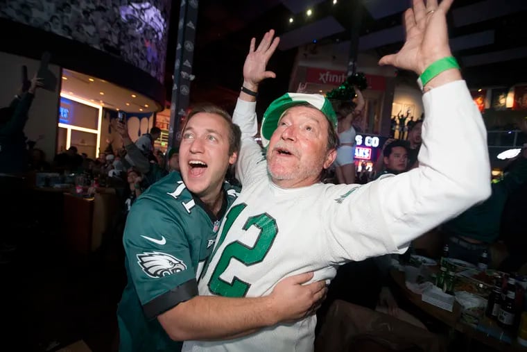 Phil, left, and his father Robert DiTullio celebrate as Brandon Graham forced a Tom Brady fumble in the 4th quarter. The Eagles defeated the Patriots in the Super Bowl LII. They were part of 3,000 fans attending a sold-out Super Bowl Party at Xfinity Live! on Feb. 4, 2018. CHARLES FOX / Staff Photographer 