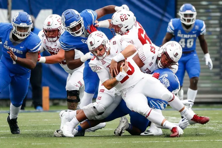 Temple quarterback Anthony Russo is sacked by the Memphis defense.