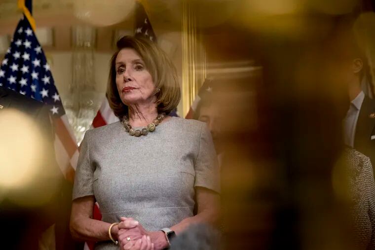 House Speaker Nancy Pelosi of Calif., accompanied by House Democratic members, listens to a reporters question after signing a deal to reopen the government on Capitol Hill in Washington, Friday, Jan. 25, 2019.