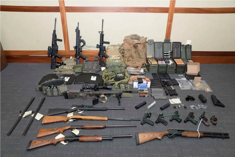 This image provided by the U.S. District Court in Maryland shows a photo of firearms and ammunition that was in the motion for detention pending trial in the case against Christopher Paul Hasson. Prosecutors say that Hasson, a Coast Guard lieutenant, is a "domestic terrorist" who wrote about biological attacks and had a hit list that included prominent Democrats and media figures. He is due in court on Feb. 21 in Maryland. Prosecutors say Hasson espoused extremist views for years. Court papers say Hasson described an "interesting idea" in a 2017 draft email that included "biological attacks followed by attack on food supply." (U.S. District Court via AP)