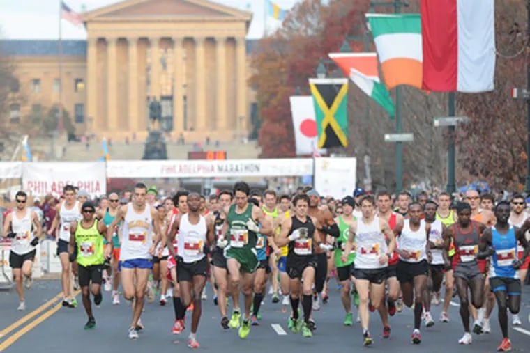 Thousands run down the Parkway to start the Philadelphia race. Two men died — a 21-year-old Penn student who ran a half-marathon and a 40-year-old who collapsed a quarter-mile short of the finish. (Sarah J. Glover / Staff Photographer)