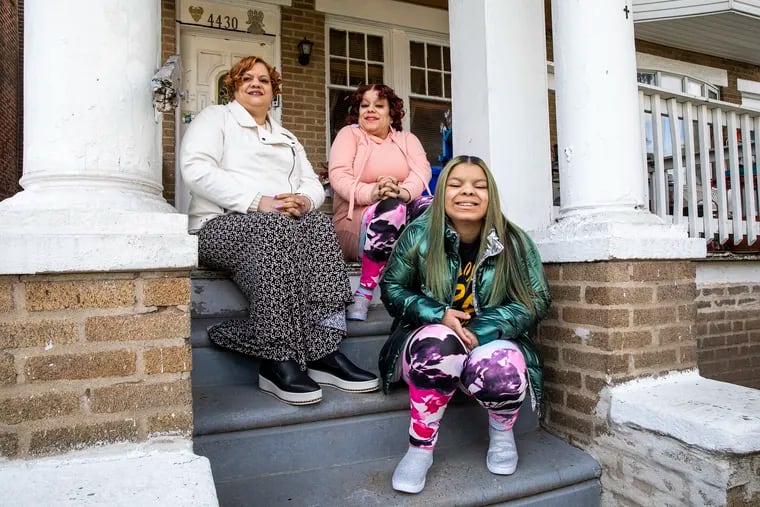 Angelique Howard, 44, (right) — shown here with her daughter Angelique Howard-Johnson, 16, (front), and sister Gabrielle Howard, 55, — needs to do some renovation of her home in Philadelphia's Hunting Park neighborhood but cannot proceed with the work because the property title is under her mother's name. Her mother, who died in 2012.