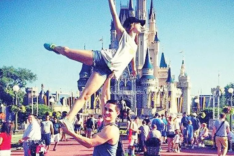 Will Ott lifts Adrienne Petrillo in front of the Magic Kingdom in Orlando, the day before beginning tour as skaters in "Disney on Ice: Frozen."