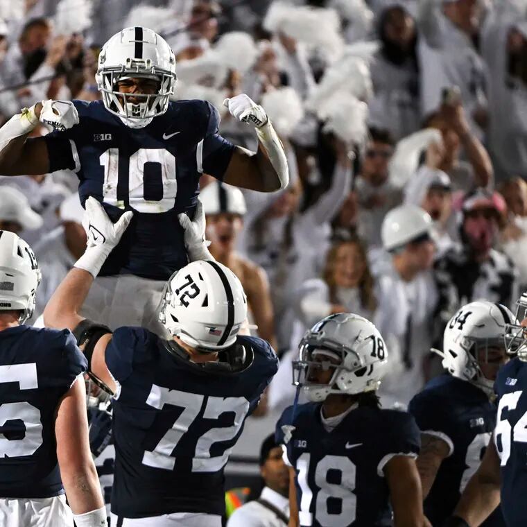 Penn State running back Nicholas Singleton is lifted by offensive lineman Bryce Effner after Singleton's touchdown against Minnesota on Oct. 22, 2022.
