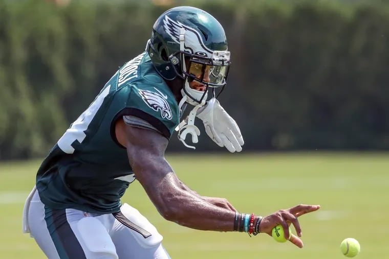 Eagles wide receiver Carlton Agudosi worked on his pass-catching skills by catching tennis balls after practice Monday.