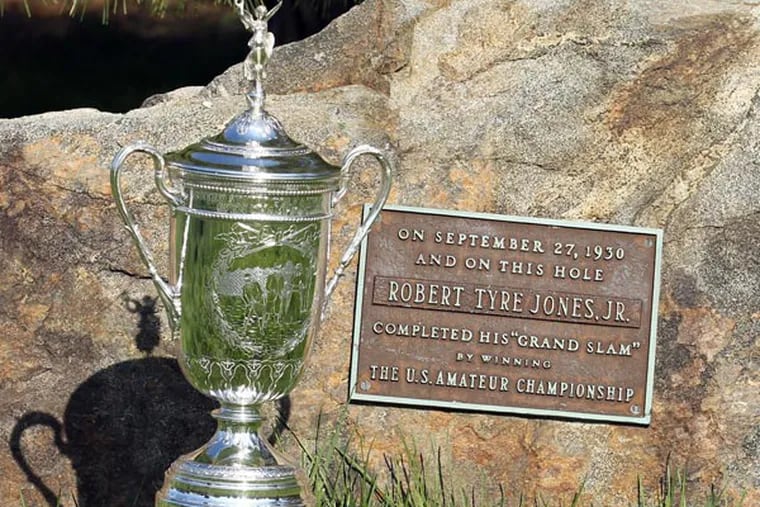 The Robert Jones plaque with the U.S. Open Trophy during the Preview Day at the par four 11th hole at Merion Golf Club East Course on Monday, April 22, 2013. The plaque commemorates Jones completing the "grand slam" of golf by winning the U.S. Amateur Championship on September 27, 1930. (Yong Kim/Staff Photographer)