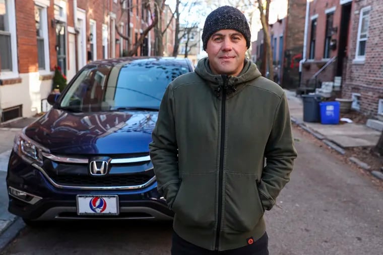 Brian McEntee with his car on Kauffman Street in South Philadelphia. The former prosecutor's car was "courtesy towed" while he was out of town. After reporting it stolen, the car was eventually found a mile away from where it had been legally parked.