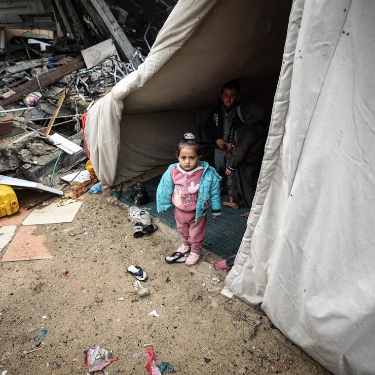 A Palestinian family lives in a tent above their destroyed house in Rafah.