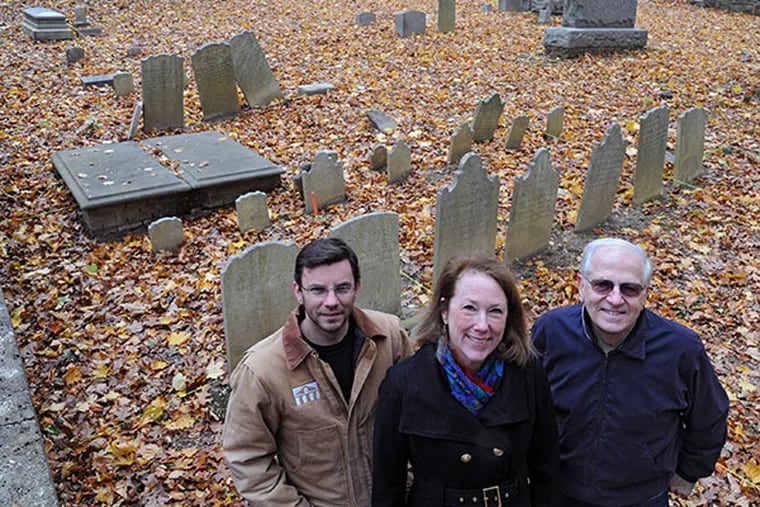 Members of the Yeakel Cemetery Preservation Committee of the Springfield Township Historical Society are (from left): Jack Yeakel, 43, Flourtown, whose 7th generation removed grandfather bought the land for the cemetery and is the first buried in the cemetery, Liz Jarvis, 58, Chestnut Hill, and Jerry Heebner, 74, Lansdale, stand inside the 1/8th acre cemetery Nov. 12, 2013.   ( CLEM MURRAY / Staff Photographer )