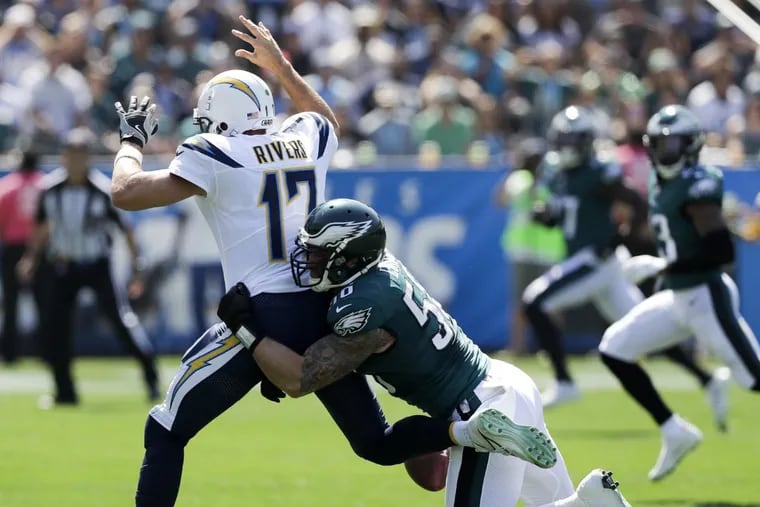 Eagles defensive end Chris Long forces a first-quarter fumble against Los Angeles Chargers quarterback Philip Rivers on Sunday, October 1, 2017 in Carson, CA. YONG KIM / Staff Photographer