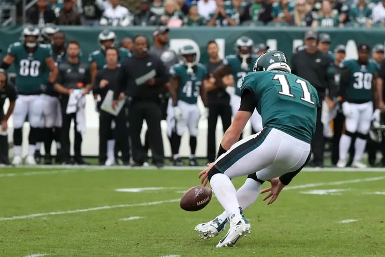 Eagles quarterback Carson Wentz chases the ball down after a high snap goes over his right shoulder during the first quart of the game against the New York Jets on Sunday, October 6, 2019 at Lincoln Financial Field in Philadelphia.