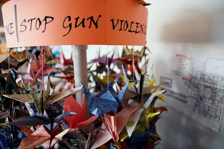 In this March 23, 2019, file photo, origami cranes, a symbol of peace, hang in the Columbine High School library in Littleton, Colo., near where several survivors and family members of the victims gathered to speak about the upcoming 20th anniversary of the April 20, 1999, shooting. In the two decades since the Columbine High School massacre, therapists still struggle with how to help people cope.