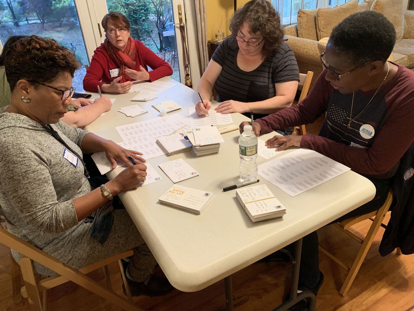 From left, Julie Dennis, Kathi Cobb, Shannon Coulter and Pamela Brug, address postcards a few days before the 2019 Election Day. They are part of Action Together New Jersey's Post-it Posse, which reached nearly 300,000 voters in 2018 midterms.