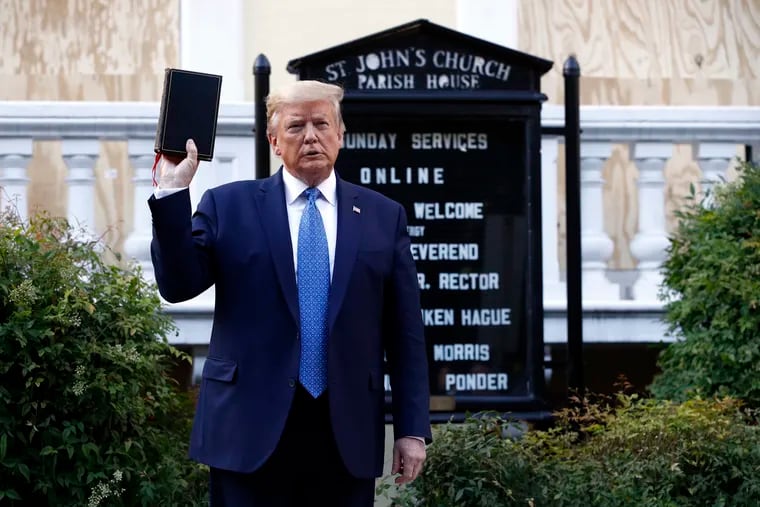 President Donald Trump holds a Bible as he visits outside St. John's Church across Lafayette Park from the White House.