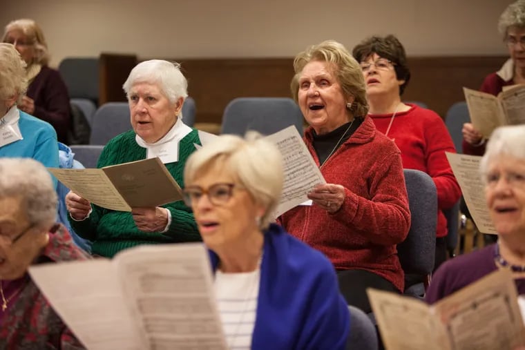 Jean Ruff, 89, (center right) sings along with the other members of the Singing for Life choir as they practice together at their weekly choral rehearsal at Bryn Mawr Presbyterian Church. EMILY COHEN / For the Inquirer