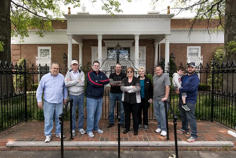 Members of the Upper Holmesburg Civic Association (from left) Stanley Cywinski, Ed Rice, Tom Geisler, Dan Collins, Nancy Quinn, Marianne Letterio, Pete Montini, Liam Cywinski, 5, and Matthew Cywinski, in front of the former Rosewood Caterers on Frankford Avenue.