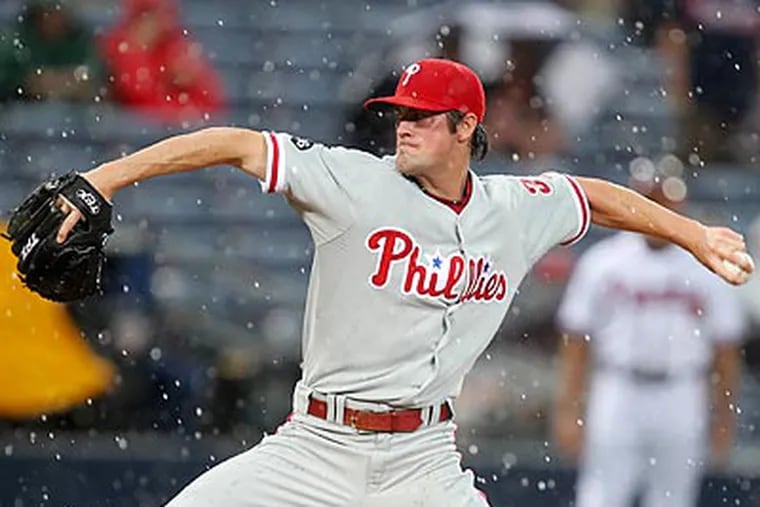 A rain delay in the first inning knocked Cole Hamels from the game after facing only five batters. (John Bazemore/AP)