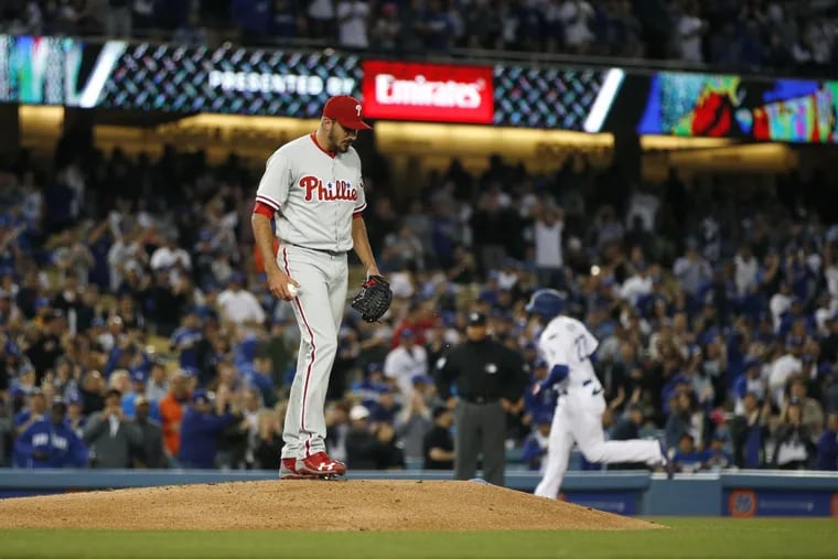 Phillies starting pitcher Zach Eflin stands on the mound as Dodgers outfielder Matt Kemp rounds the bases on Wednesday.