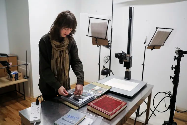 Claire Iltis, associate director at Philly's Fleisher/Ollman Gallery, flips through drawings by Dorothy F. Foster. She found them gathering dust in an antique store in Port Jervis, N.Y.