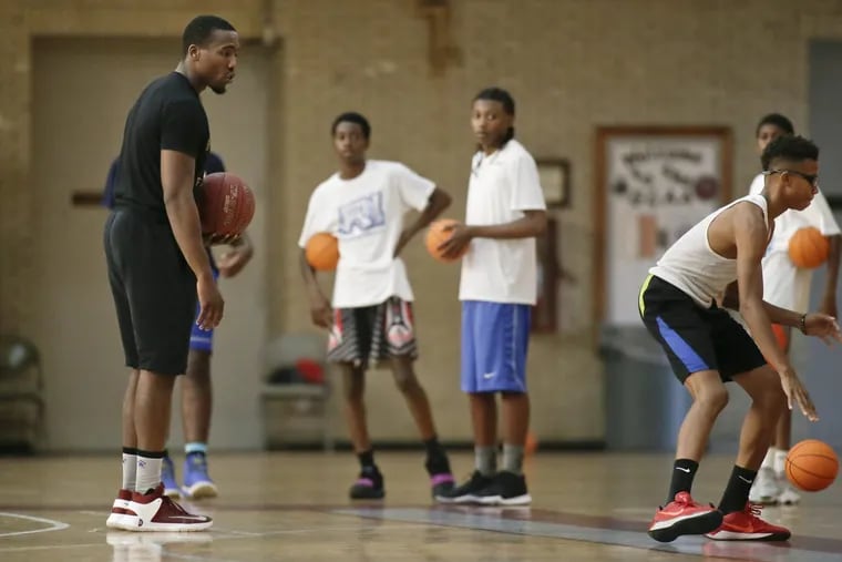 Tasheed Carr (left) teaches all around basketball skills during a training session at the Girard College gym in Phila., Pa. on October 4, 2017.