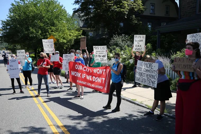 Workers from the Free Library of Philadelphia protested outside the home of library Board of Trustees President Pamela Dembe's home in Philadelphia on Monday.