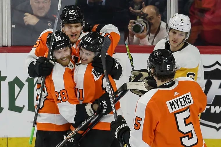 The Flyers' James van Riemsdyk (25) celebrates his goal with teammates Claude Giroux (28) and Travis Konecny (11) near the Penguins' John Marino at the Wells Fargo Center on Jan. 21. The Flyers defeated the Penguins, 3-0.