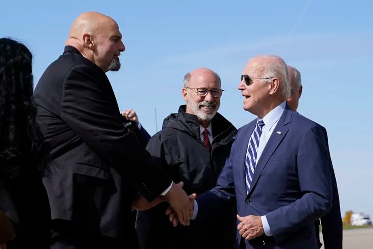 President Joe Biden speaks with Lt. Gov. John Fetterman after stepping off Air Force One.