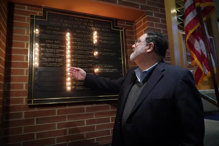 Historian and Rabbi Lance Sussman, of Reform Congregation Keneseth Israel, points to names of veterans on a memorial plaque at the Elkins Park synagogue.