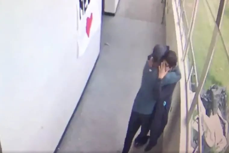 Keanon Lowe and a student emerge from a classroom and into a hallway at Parkrose High School with Lowe in possession of the shotgun in this screen grab from video released Friday by the Multnomah County District Attorney's Office.