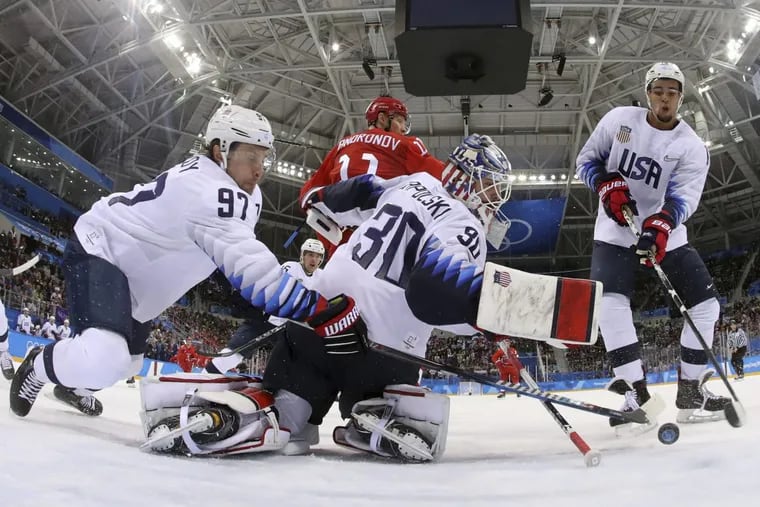 Matt Gilroy (97), goalie Ryan Zapolski (30) and Jordan Greenway (18), of the United States, reach for the puck during the first period of the preliminary round of the men’s hockey game against the team from Russia at the 2018 Winter Olympics in Gangneung, South Korea, Saturday, Feb. 17, 2018.