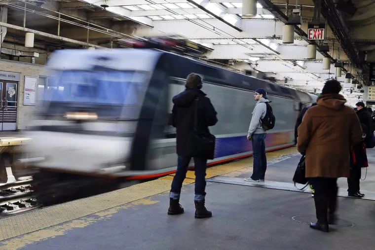 Patrons navigate the platform at the New Jersey Transit Newark Penn Station on March 4.