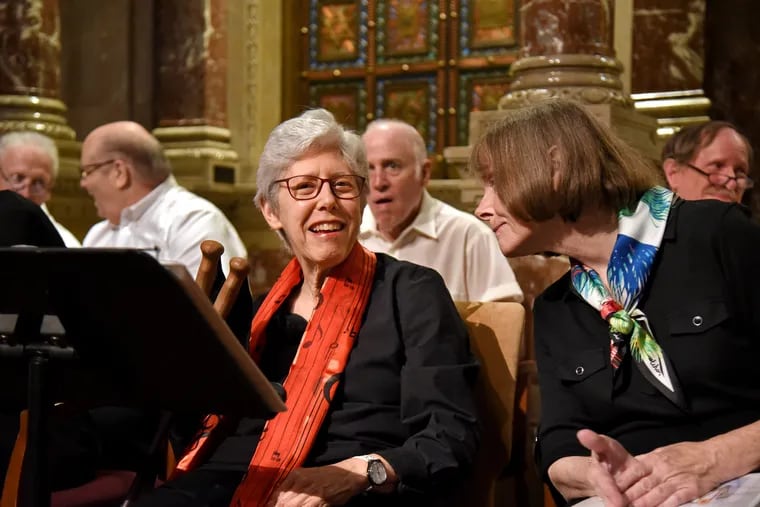 Betty Shapiro, left, of Wyncotte talks with Gail Thatcher of Olney as they prepare to perform with the ParkinSingers, a choir made up of Parkinson's disease sufferers and their friends and families, at Congregation Rodeph Shalom in June
