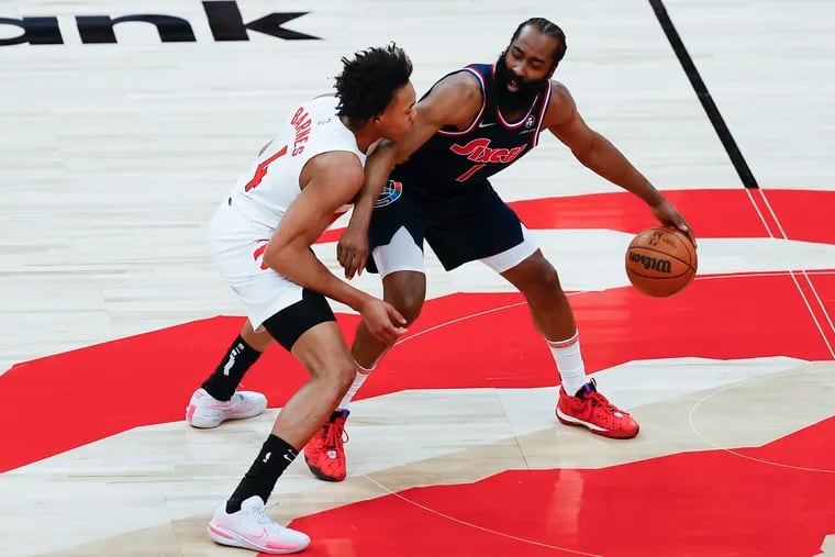 Sixers guard James Harden is guarded by Toronto Raptors forward Scottie Barnes during Game 6 of their playoff series in April.