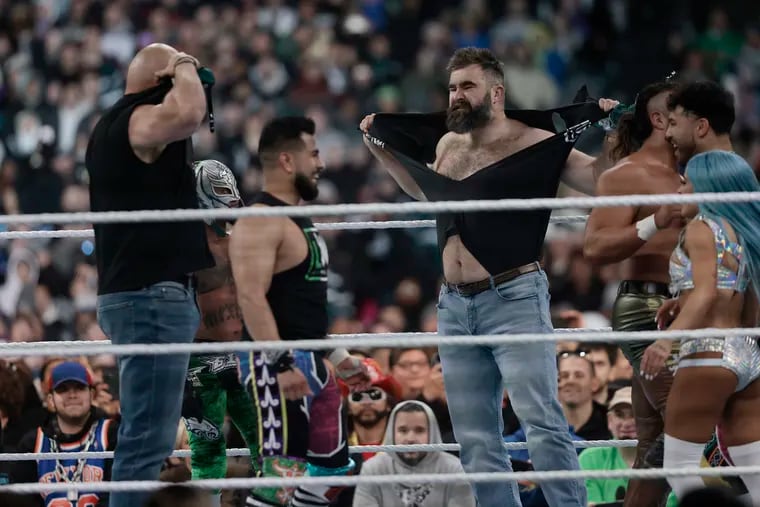 Jason Kelce, center, rips his shirt off in the ring during WrestleMania at Lincoln Financial Field on Saturday, April 6.