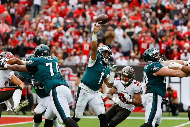 Eagles quarterback Jalen Hurts throws the  past Buccaneers safety Antoine Winfield Jr. during the fourth quarter of Sunday's NFC wild-card game in Tampa Bay.