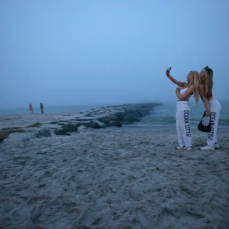 Bryanna Snell (left) and Kylie Spickenreuther of Vineland pose for selfies on the Ocean City beach around 8:30 pm on Memorial Day weekend, Sunday, May 26, 2024. Even though the beach was technically to be closed at 8 pm, Spickenreuther said “instagram comes first”.