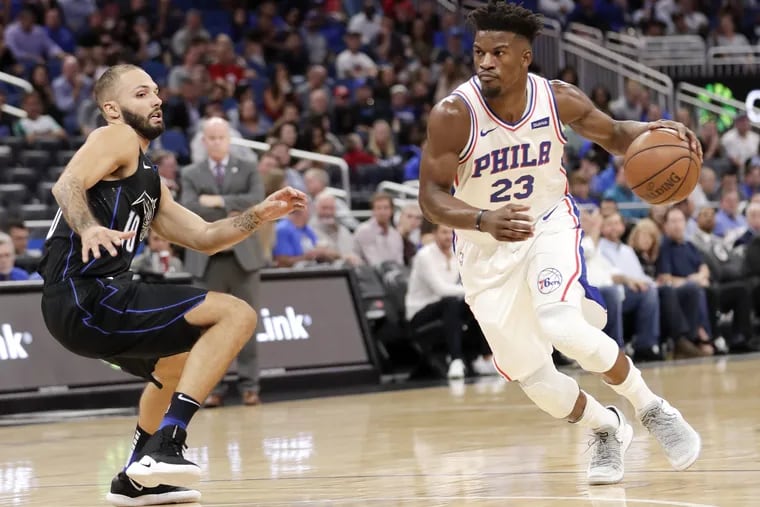 Sixers'  Jimmy Butler drives past Orlando's Evan Fournier during the first half