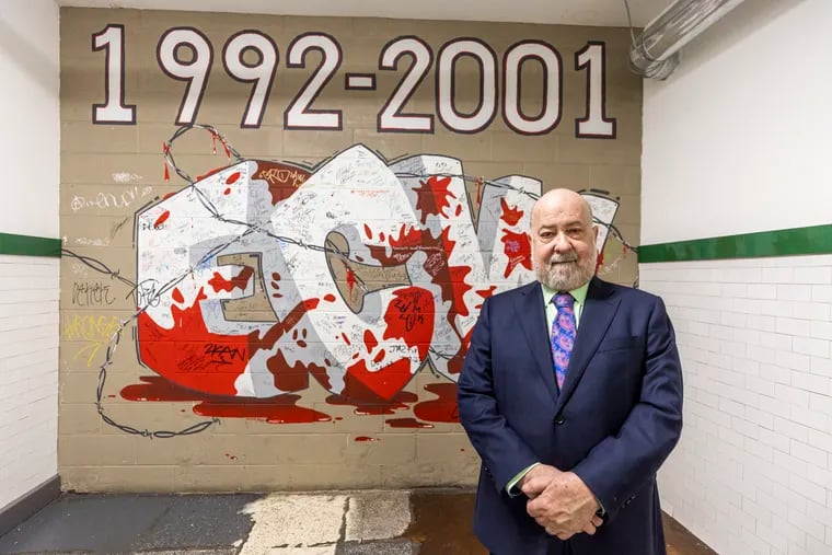 Tod Gordon poses for a photo of the ECW mural at the 2300 Arena in South Philadelphia.