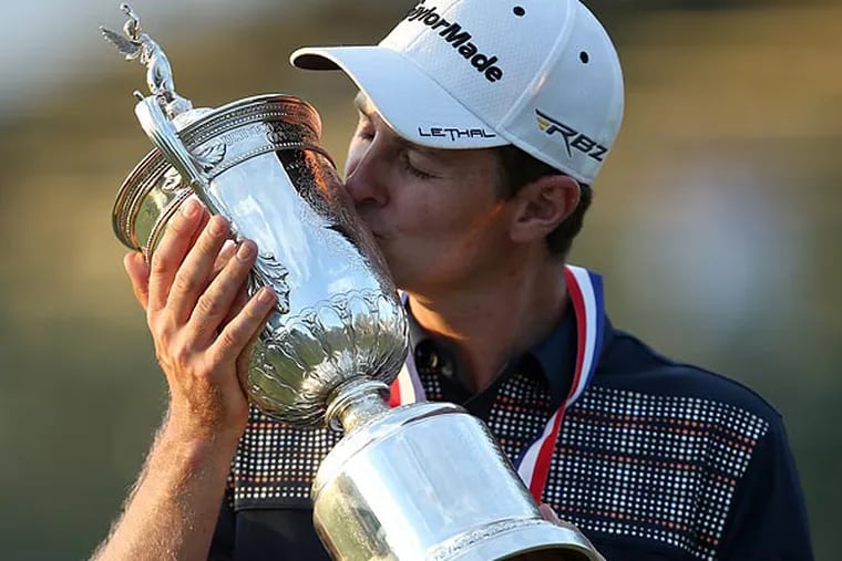 Justin Rose kisses the trophy after winning the U.S. Open golf tournament at Merion Golf Club. (Yong Kim/Staff Photographer)