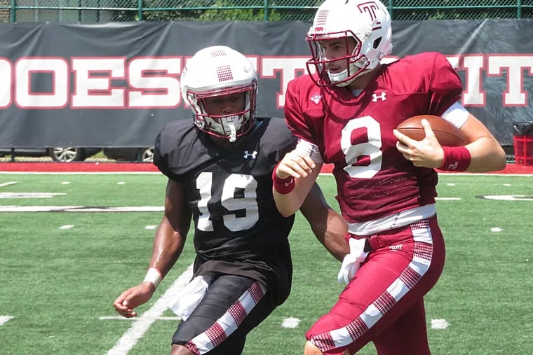 Temple QB Frank Nutile is chased out of bounds by LB Isaiah Graham-Mobley during Thursday's practice.
