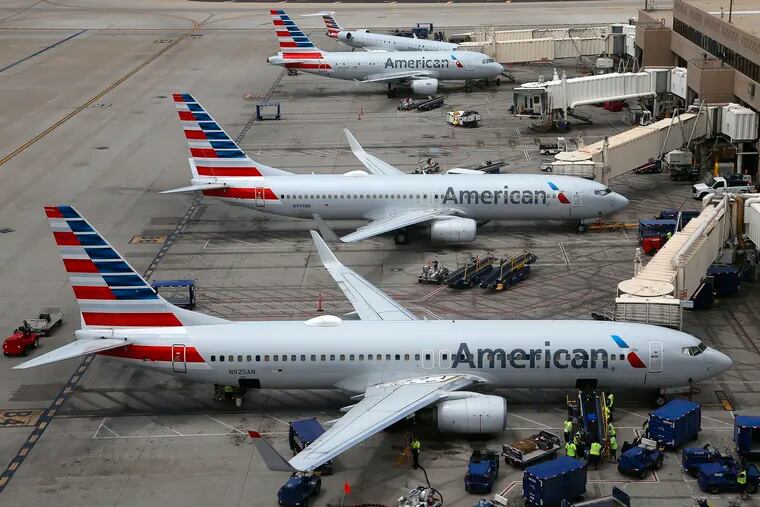 FILE - This July 17, 2019, file photo shows American Airlines planes at Phoenix Sky Harbor International Airport in Phoenix. American Airlines wants two labor unions to pay damages and the company’s attorney fees, saying they ignored a judge’s order to quickly end a work slowdown by mechanics. (AP Photo/Ross D. Franklin, File)