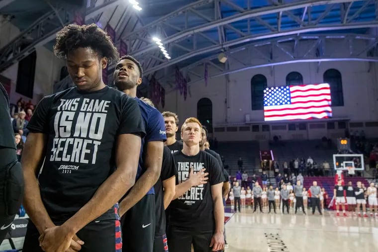 Penn players stand for the national anthem before their game against Cornell at the Palestra on Feb. 4, 2023.