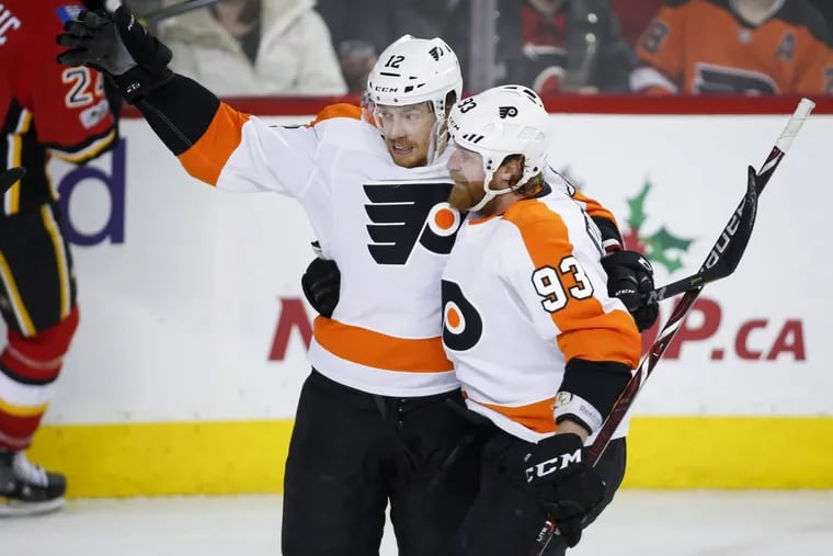 Michael Raffl, left, , celebrating his goal with teammate Jakub Voracek during second-period action against Calgary on Monday.