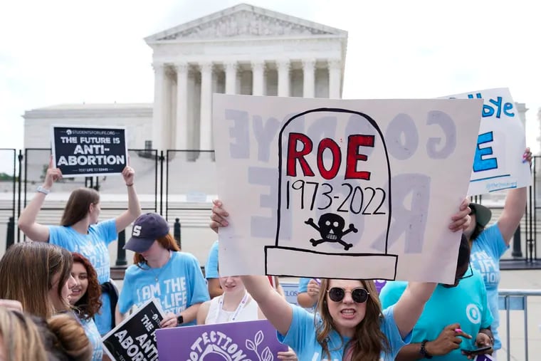 Demonstrators gather outside the U.S. Supreme Court Building in Washington last June, hours after the justices issued the "Dobbs" decision eliminating federal protections for abortion rights.