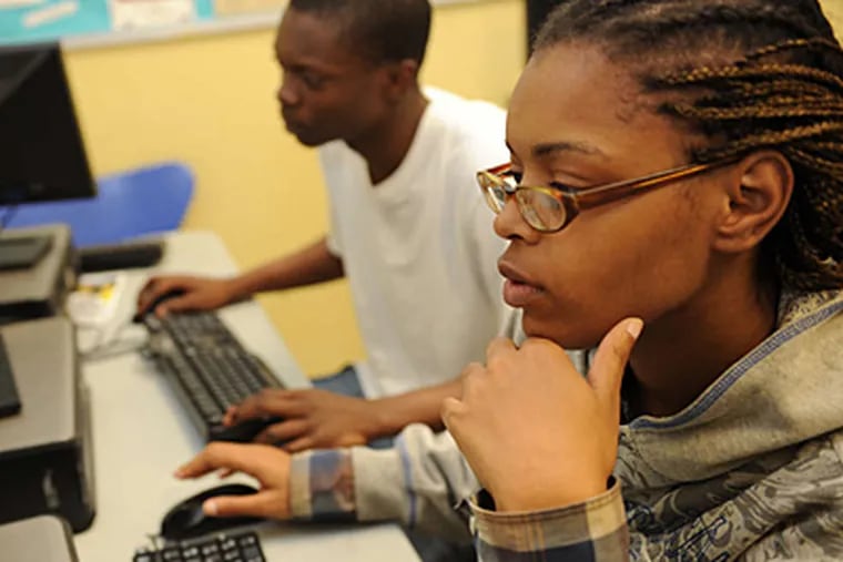 YESPhilly students April Bryant, 21, and Robert Goodson, 18, study a software program.